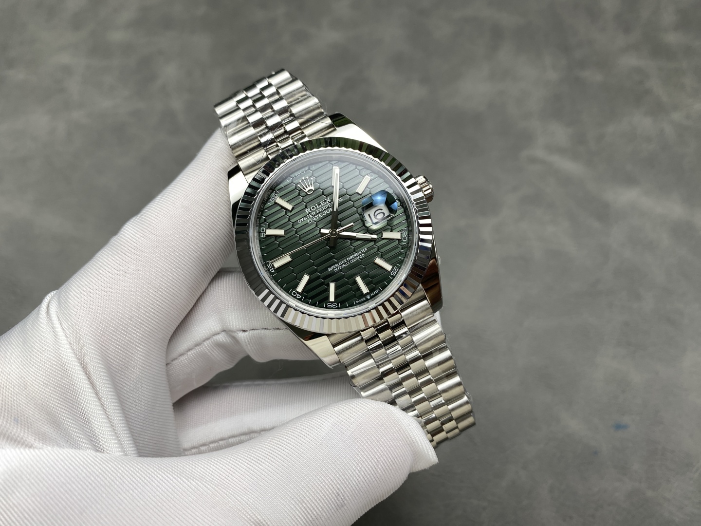 Rolex Datejust replica 41mm green fluted dial held in hand