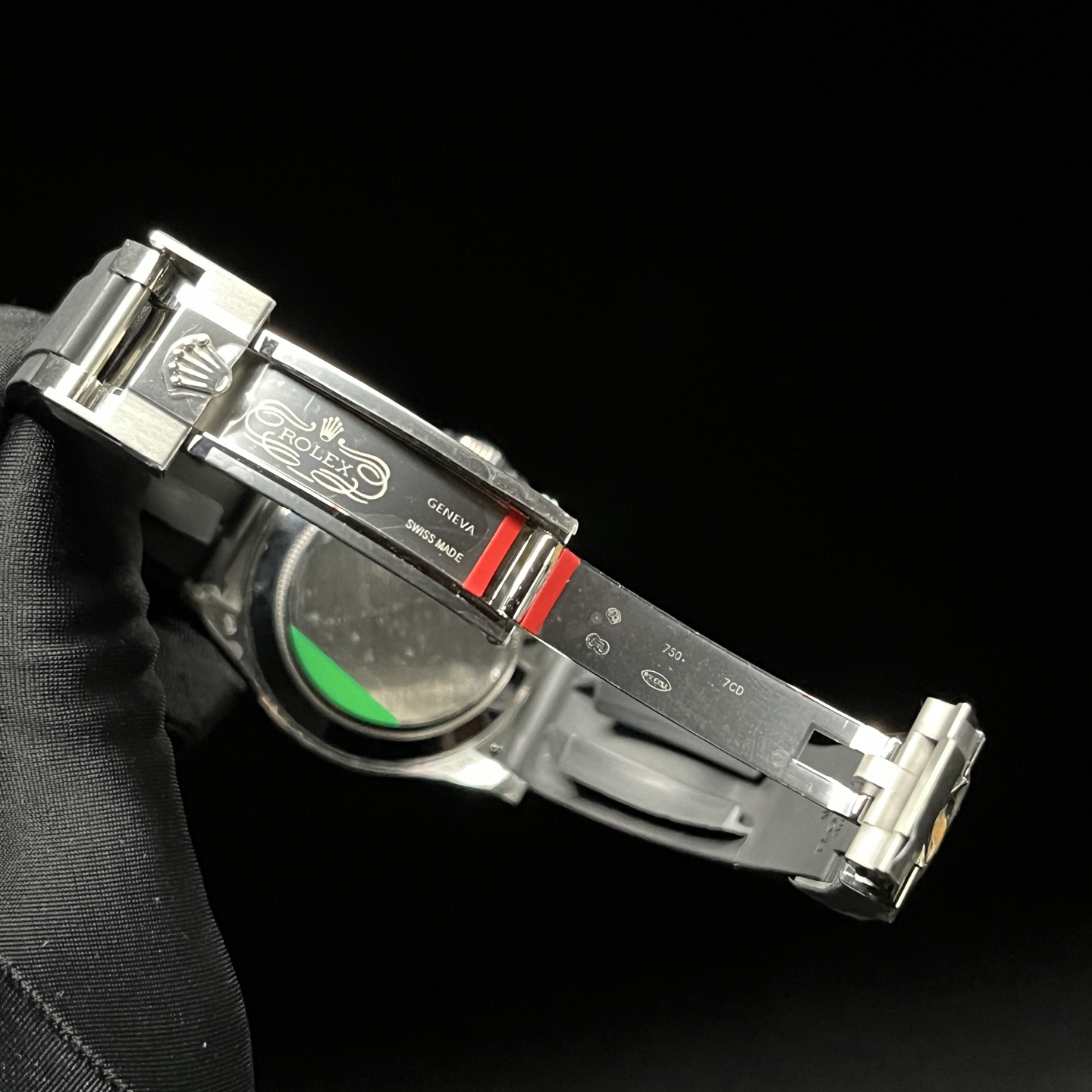 Clasp detail of Rolex Daytona style replica watch with engraved inner blade and rubber strap