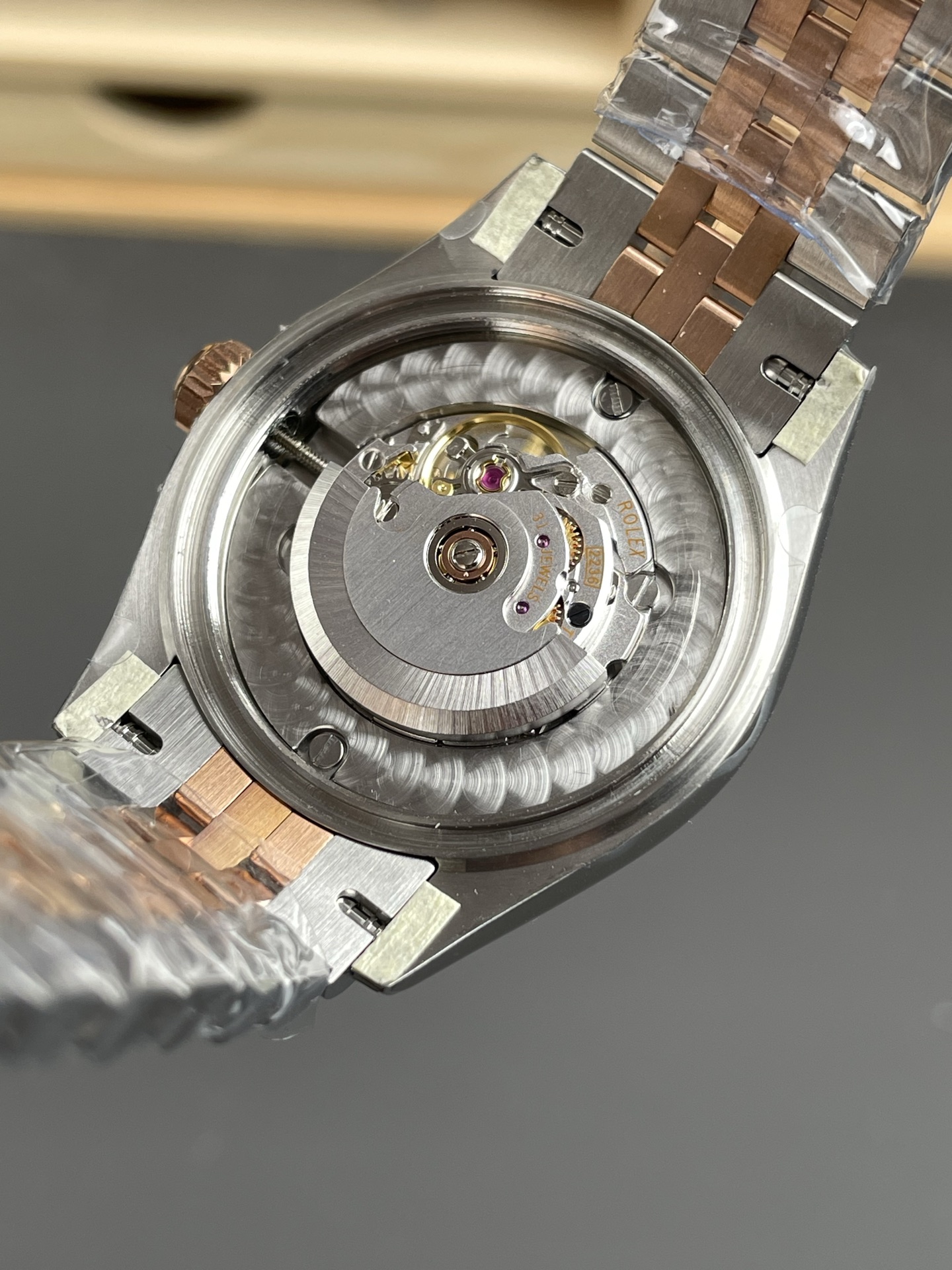 Transparent sapphire caseback revealing engraved 2236 movement rotor with 31 jewels in high-end Rolex replica