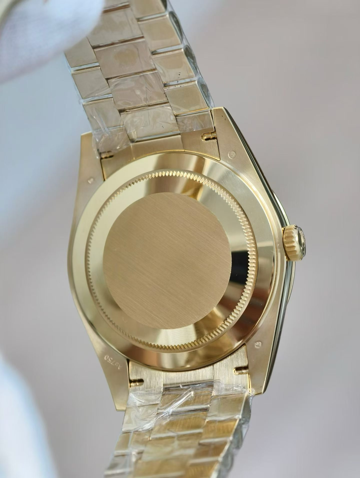 Detailed shot of the gold President-style bracelet links and deployant clasp on Rolex replica
