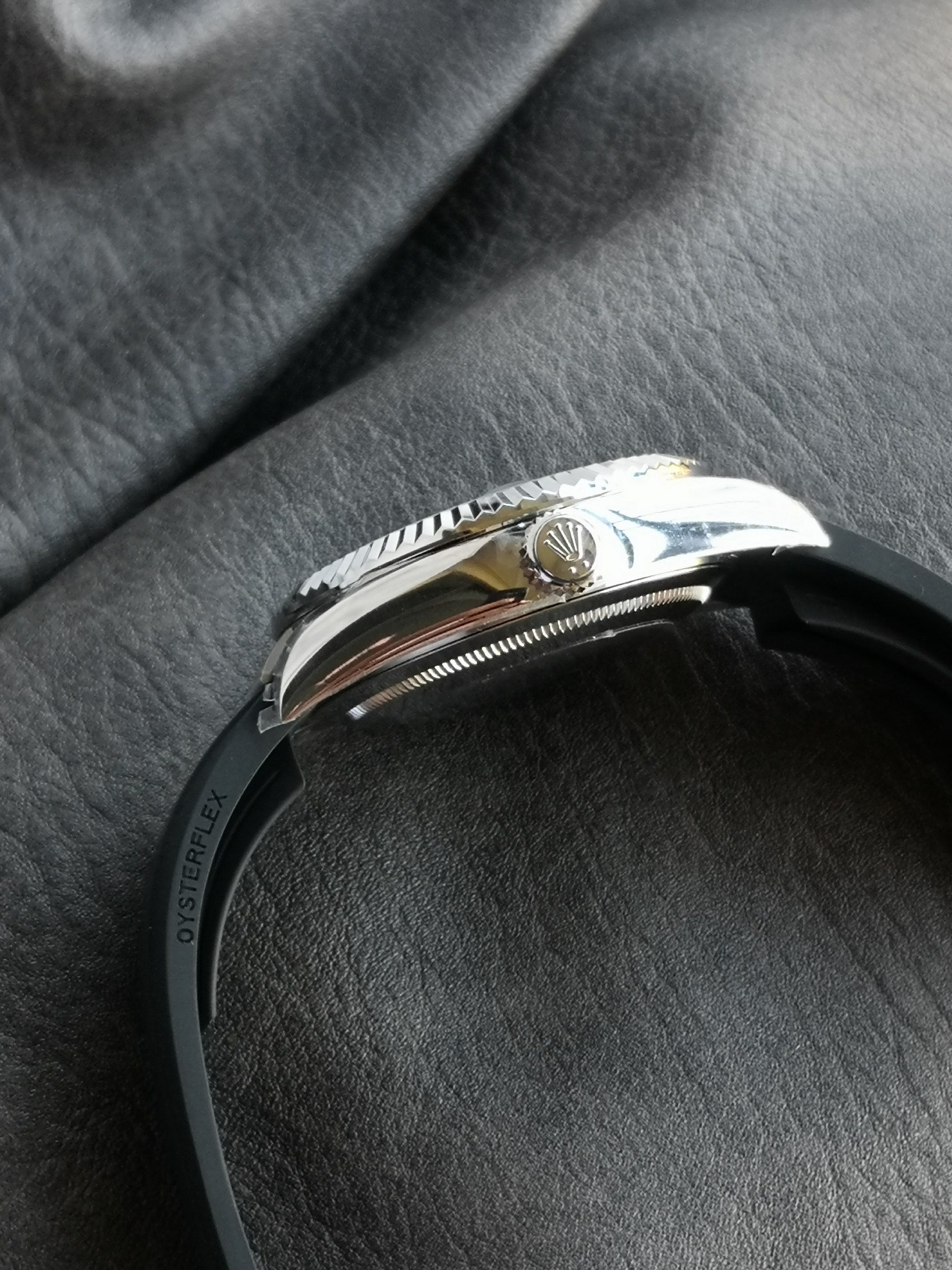 Side profile view showing the fluted bezel, crown guard, and Oysterflex strap embossing