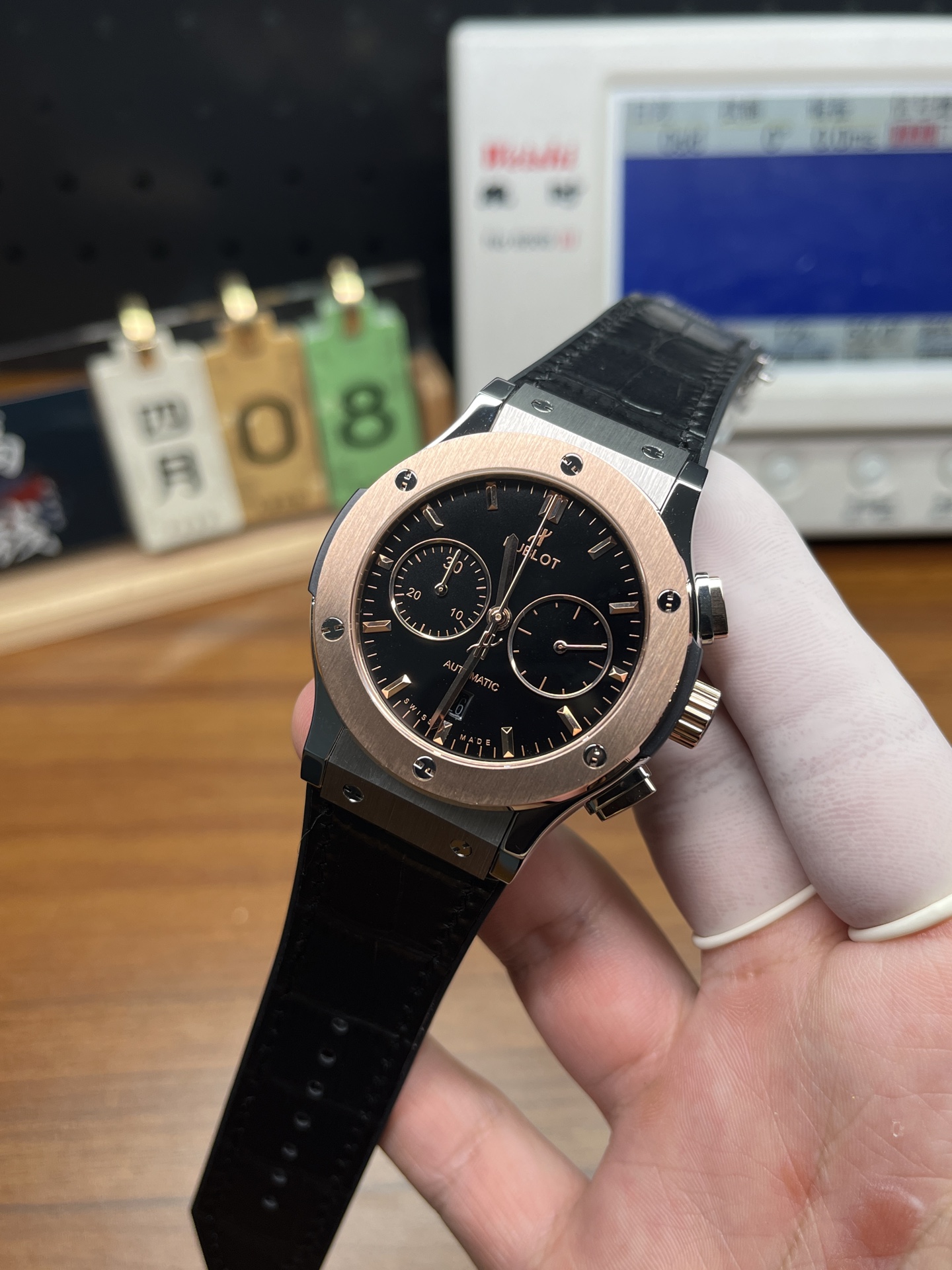 Hublot replica watch front dial with rose gold bezel and black strap