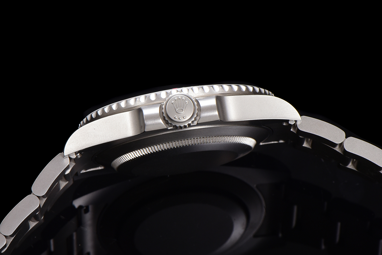 Close-up side profile of Rolex Submariner showing the fluted crown with Rolex logo and protective crown guards