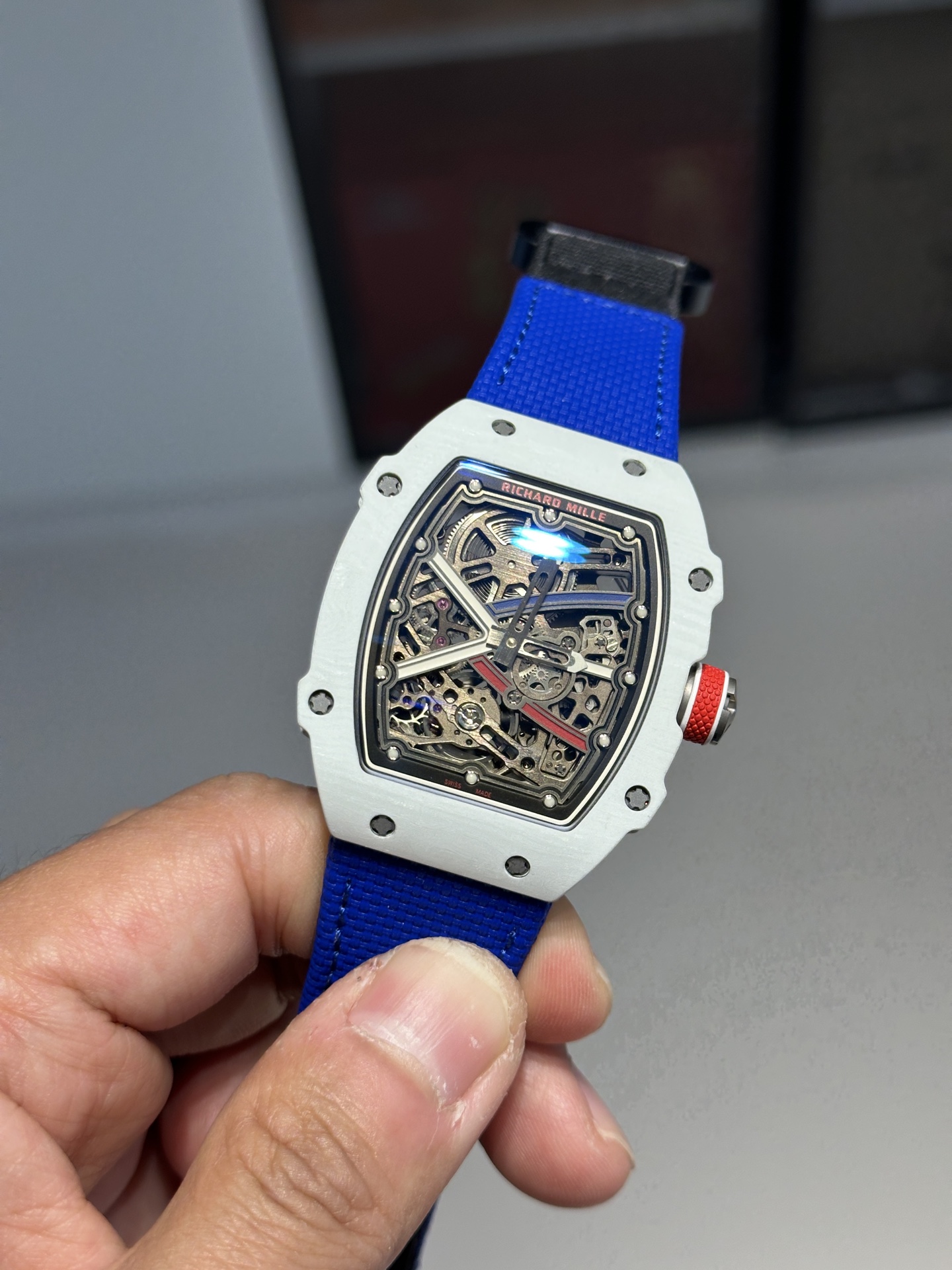 Close-up of Richard Mille replica dial with blue strap and red crown detail