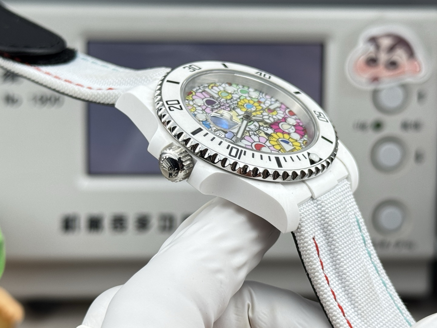 Side profile of the replica watch showing the white ceramic case, crown, and bezel