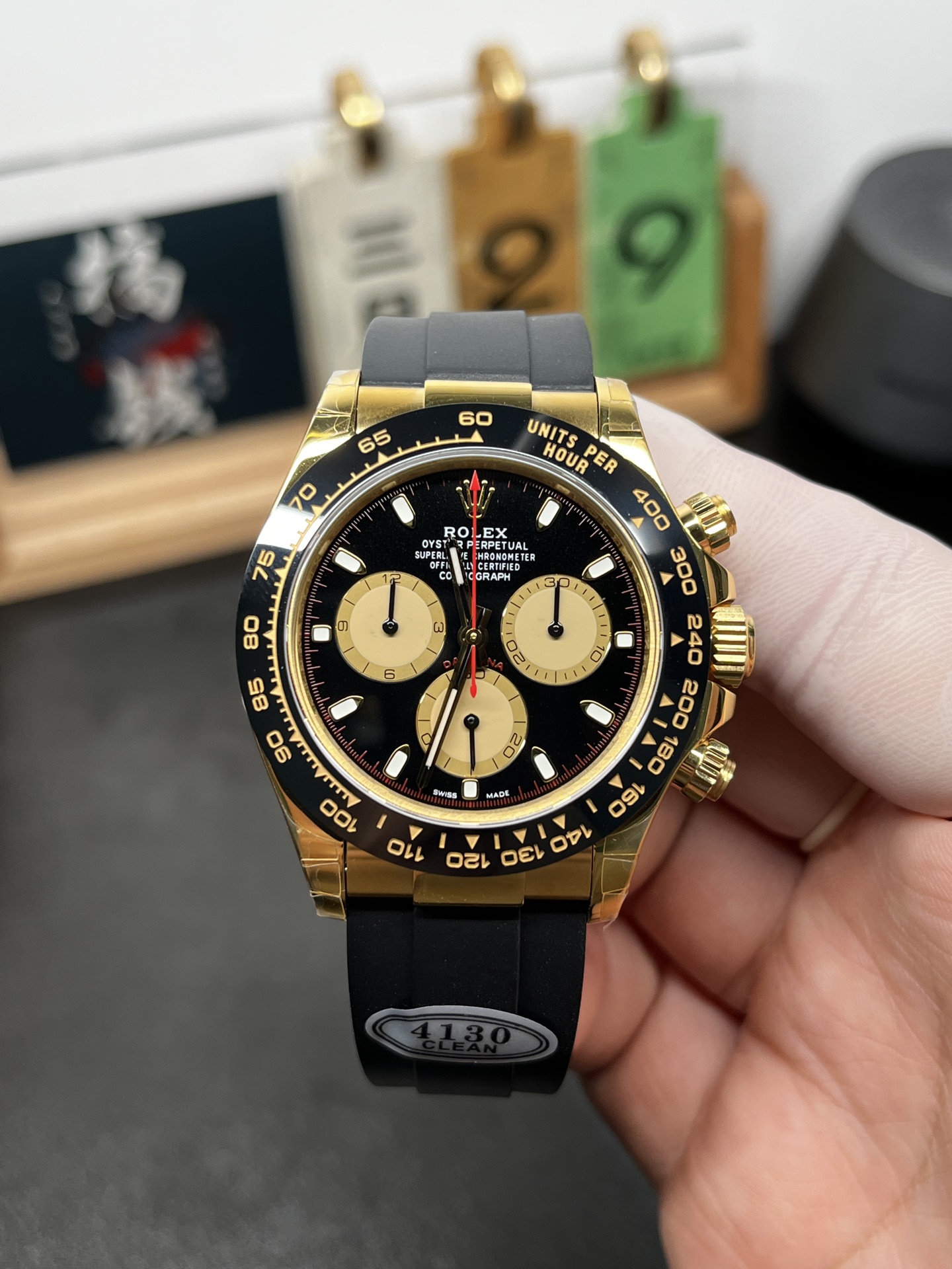 Front dial view of Clean Factory Rolex Daytona replica in yellow gold and black