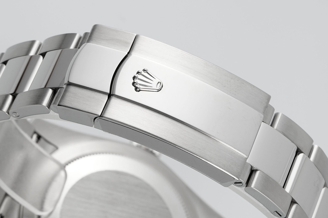 Detailed clasp close-up of the stainless steel Oyster bracelet with engraved Rolex crown logo on the deployment buckle