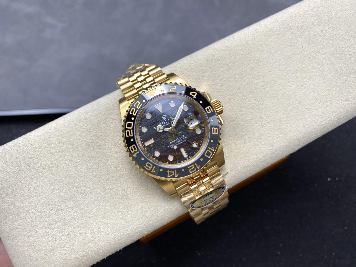 Gold Rolex GMT-Master II replica watch with black bezel and Jubilee bracelet