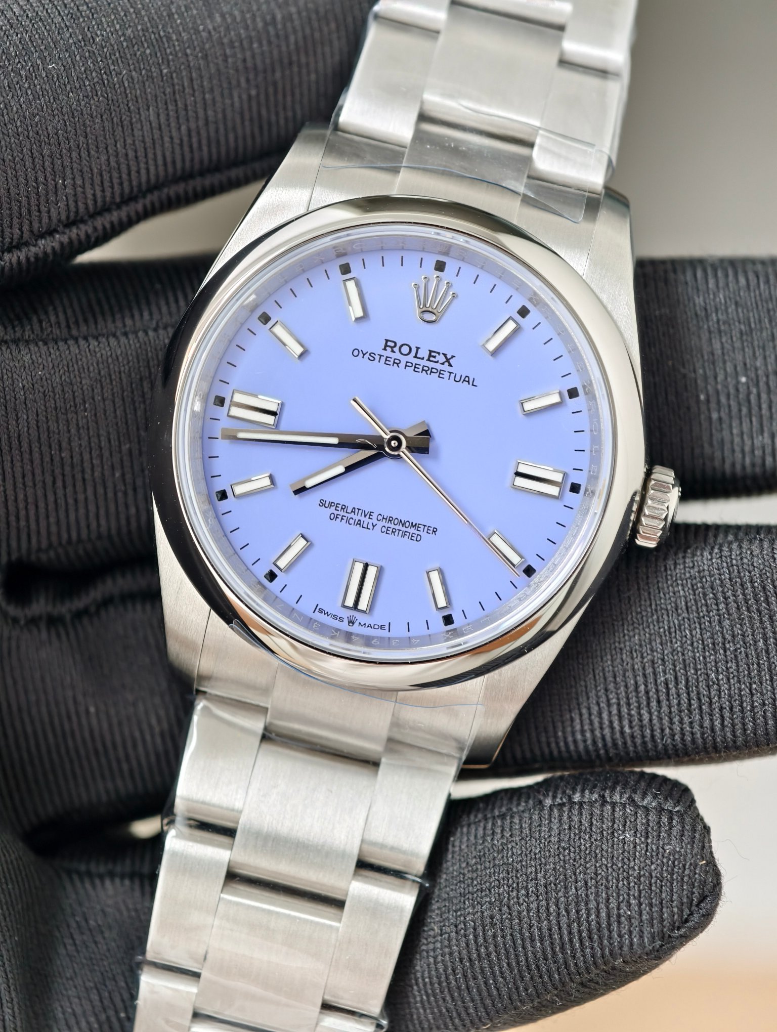 Close-up of Rolex replica Oyster Perpetual light blue dial showing crown logo and superlative chronometer text