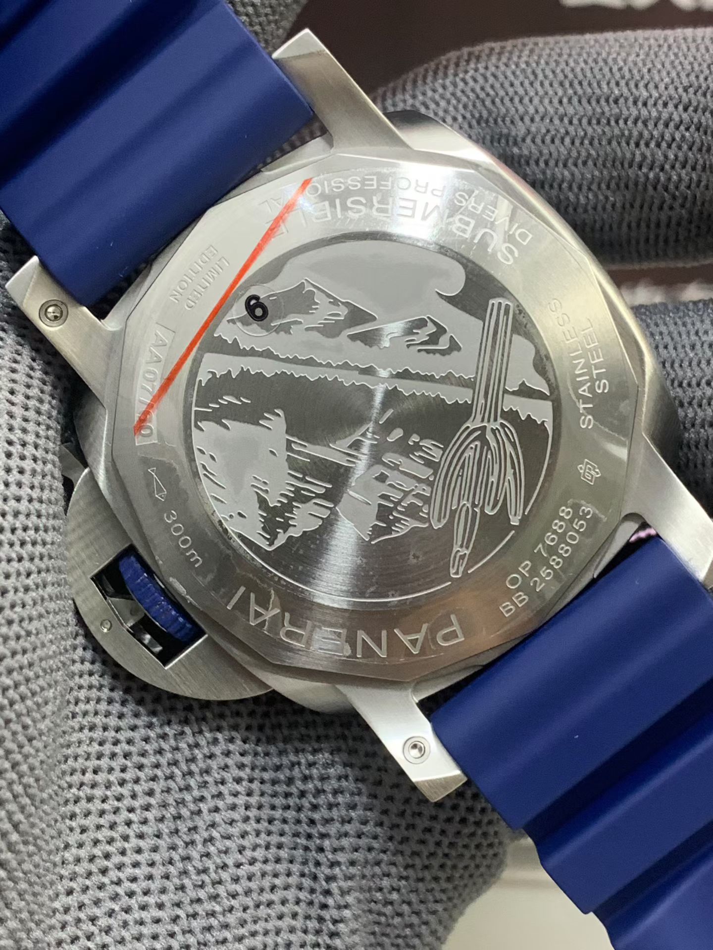 Engraved caseback of Panerai Submersible replica watch with blue rubber strap