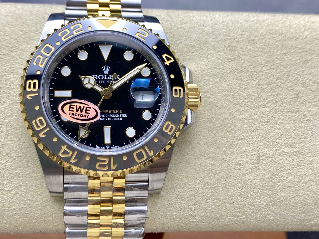 Detailed view of the black glossy dial on a high-end GMT-Master II replica featuring luminous hands, date window with Cyclops, and EWE FACTORY quality sticker