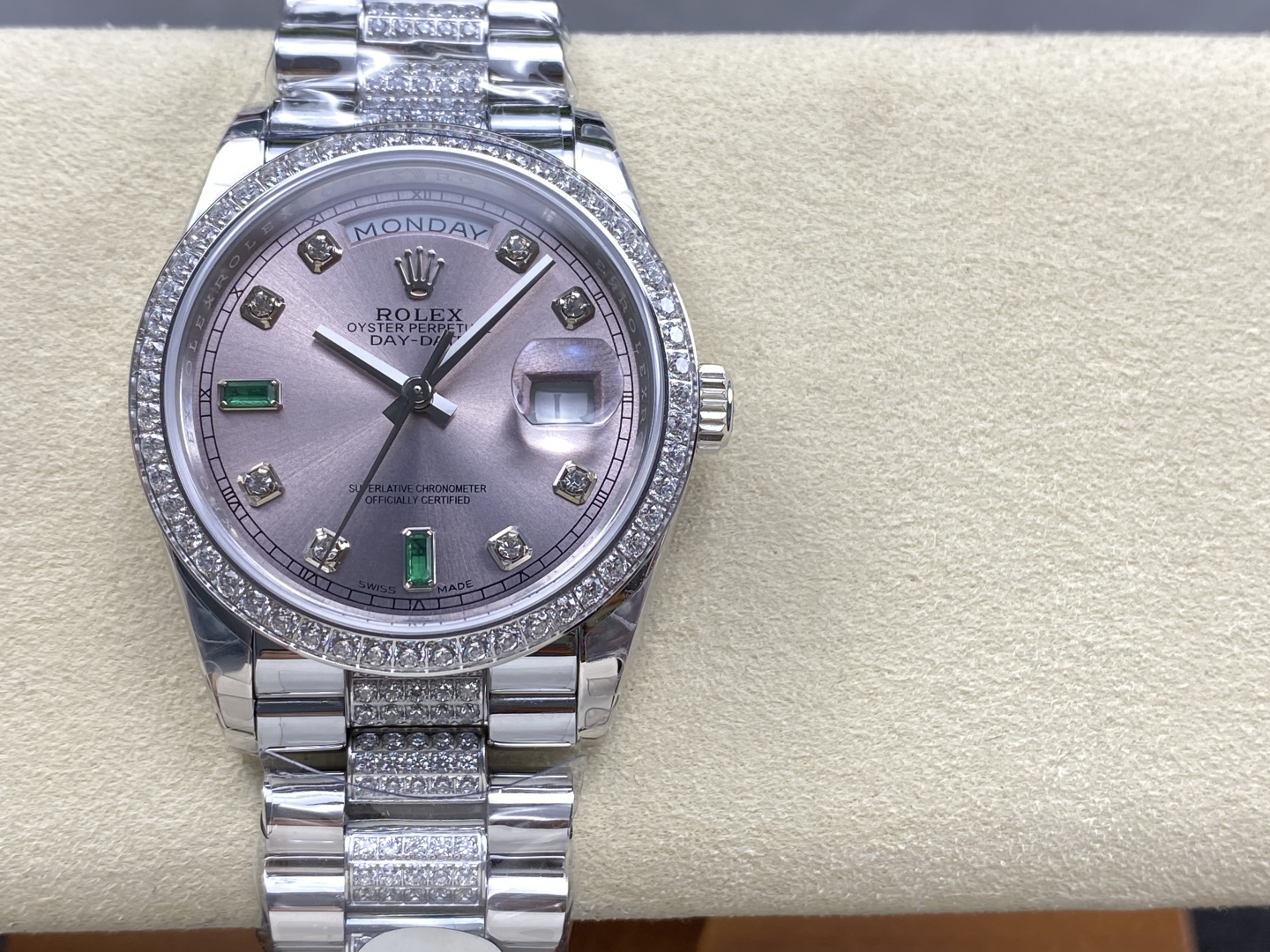 lavender dial with diamond and emerald hour markers, day-date window