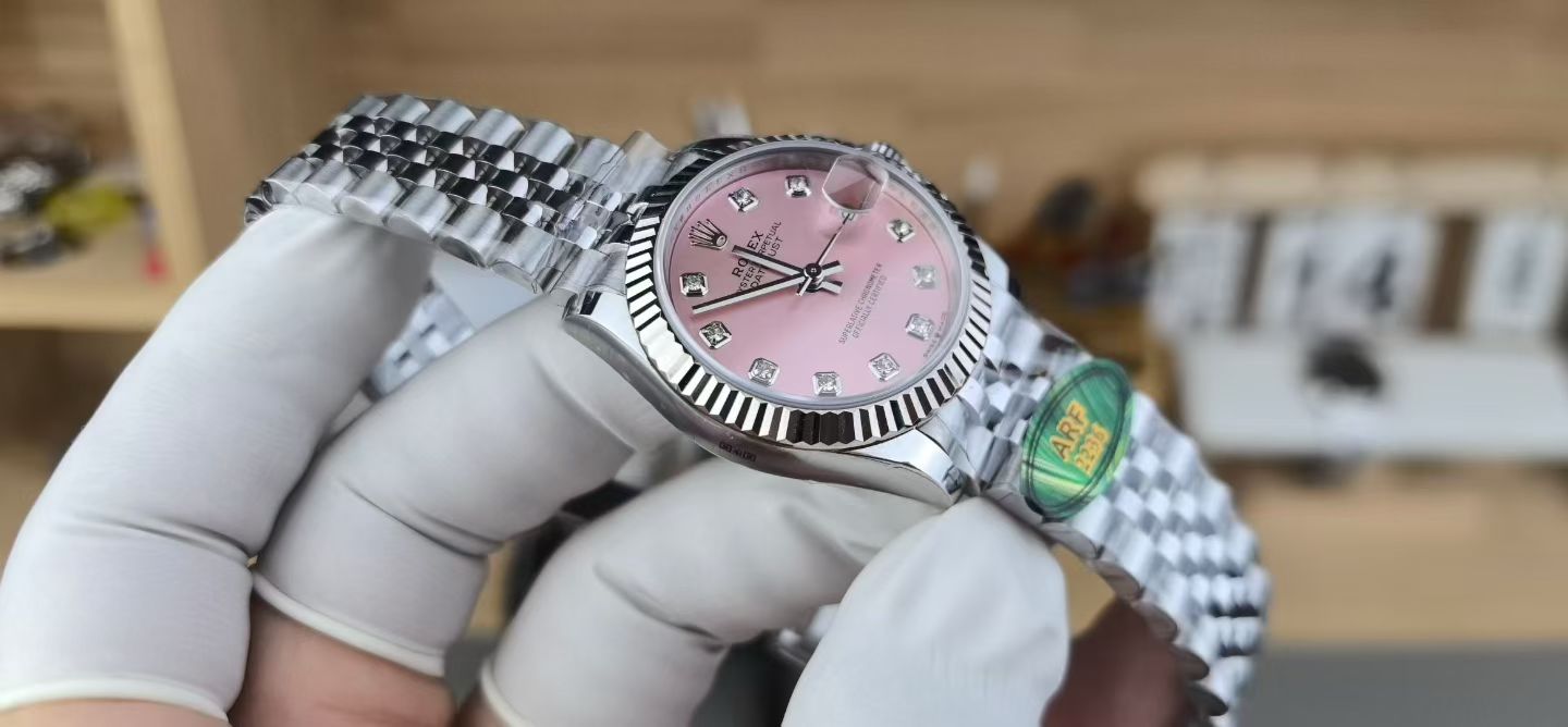 Angled pink dial Rolex replica Datejust showing fluted bezel and Jubilee bracelet finish