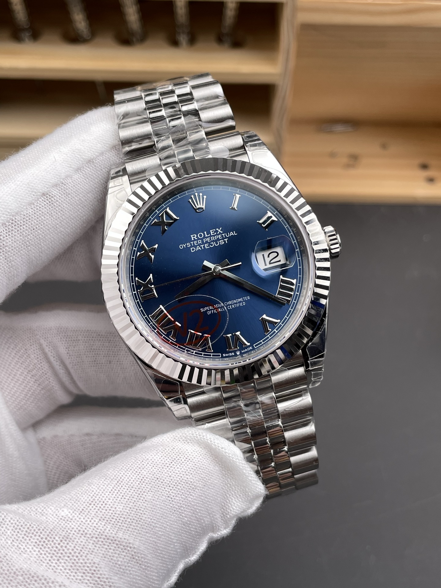 Angled front view of Rolex Datejust replica showing blue sunburst dial and fluted bezel