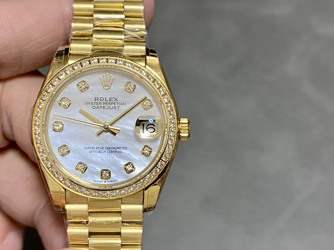 Gold Rolex Datejust replica with diamond bezel and mother-of-pearl dial