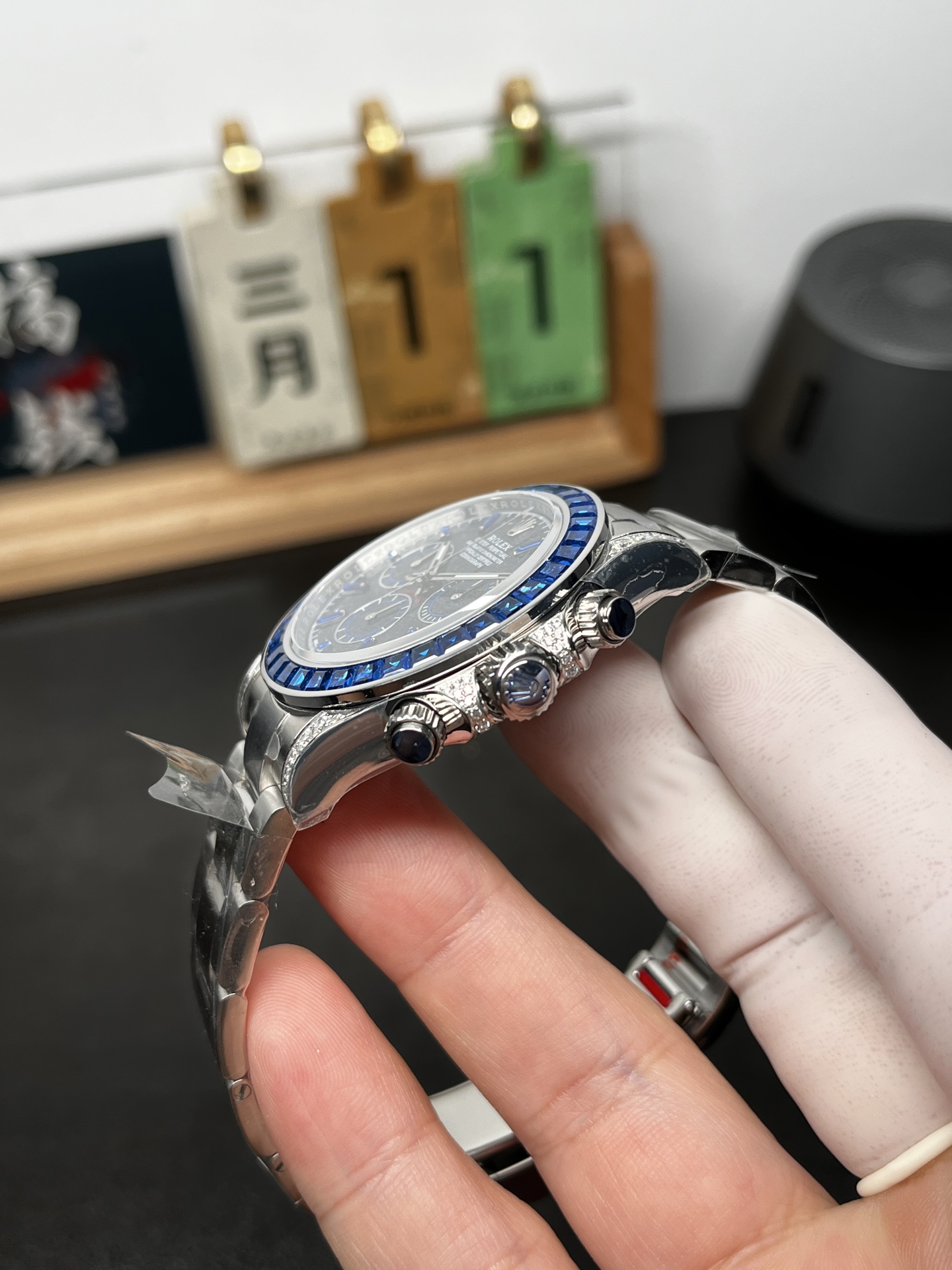 Side profile of blue bezel Rolex Daytona super clone with chronograph pushers