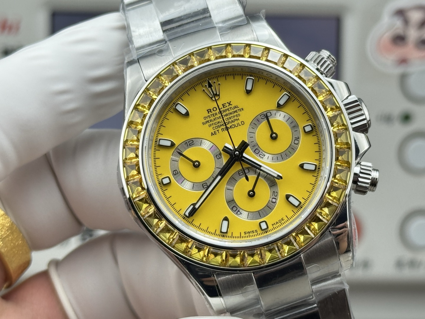 Vibrant yellow sunburst dial close-up of Rolex replica with sub-dials and applied markers demonstrating Macro Test quality