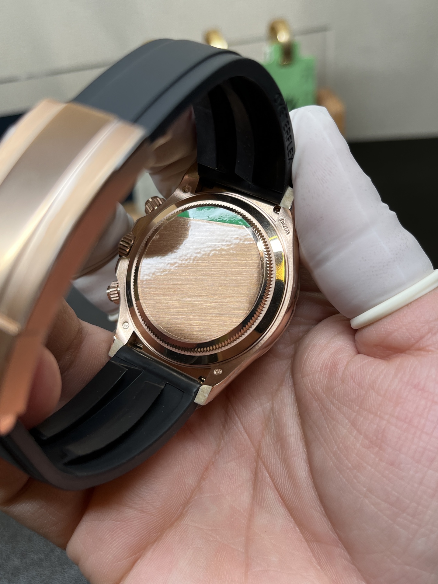 Caseback view of rose gold Rolex Daytona replica with protective film