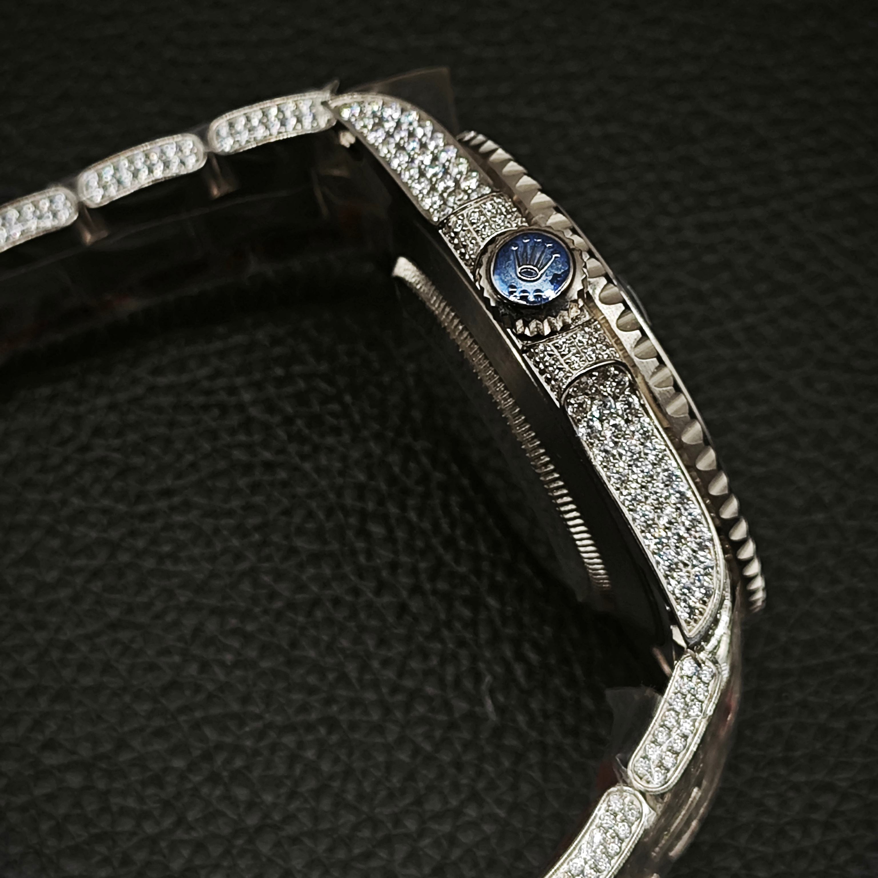 Side profile of iced Rolex replica case and blue crown detail