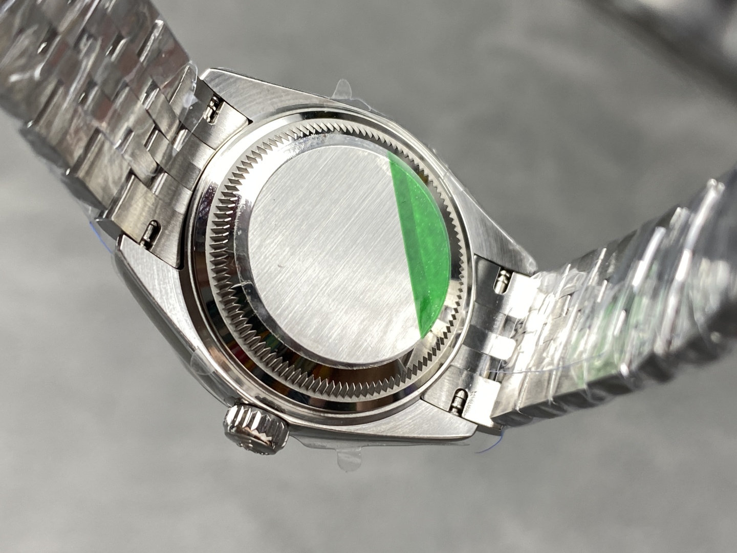 Case back of a 2236 clone movement watch with green protective sticker