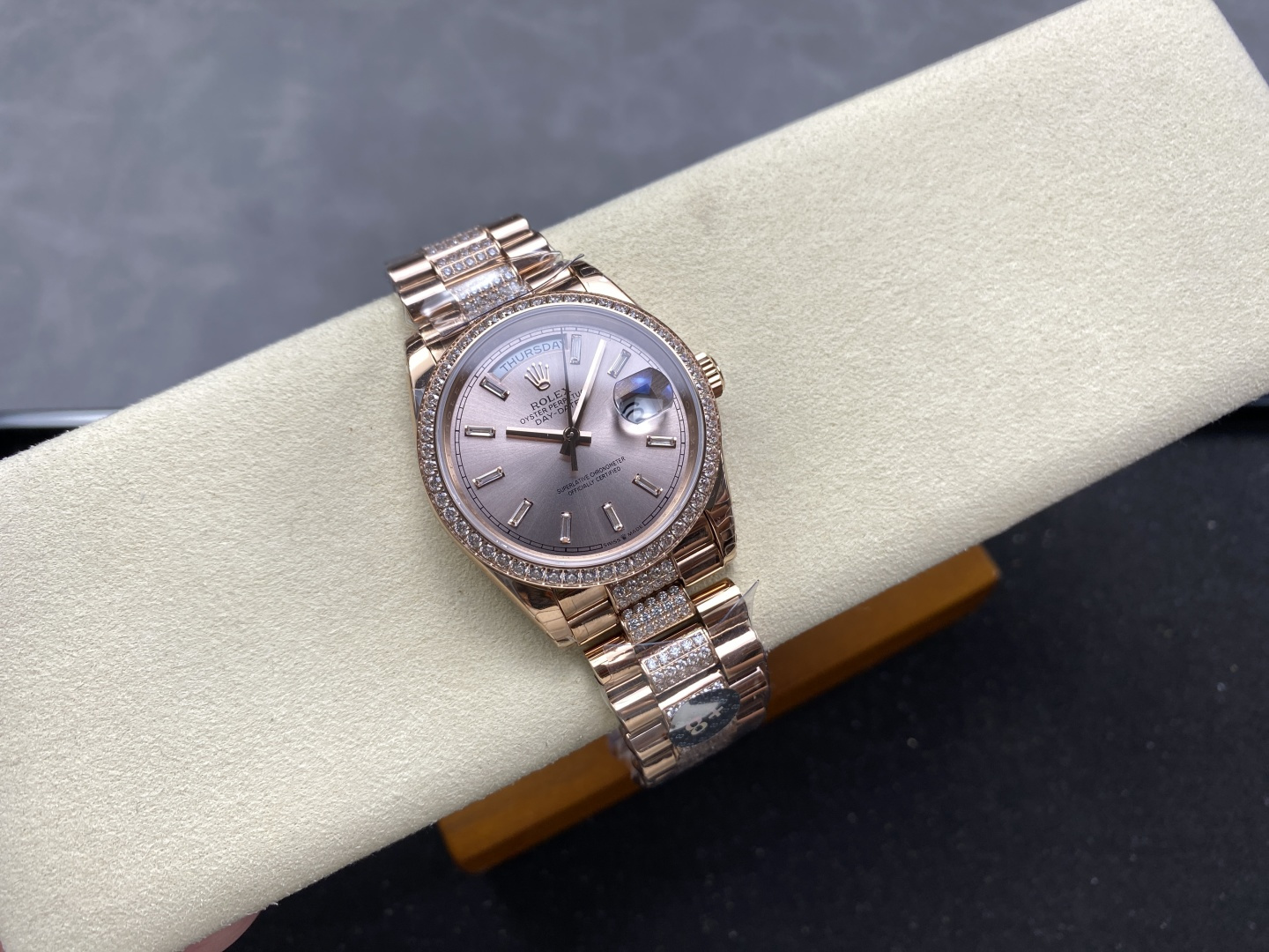 USA: Claim Your 1:1 Clone Watches Now 2 Rose gold Rolex Day-Date replica with diamond bezel and diamond dial on a white display cushion