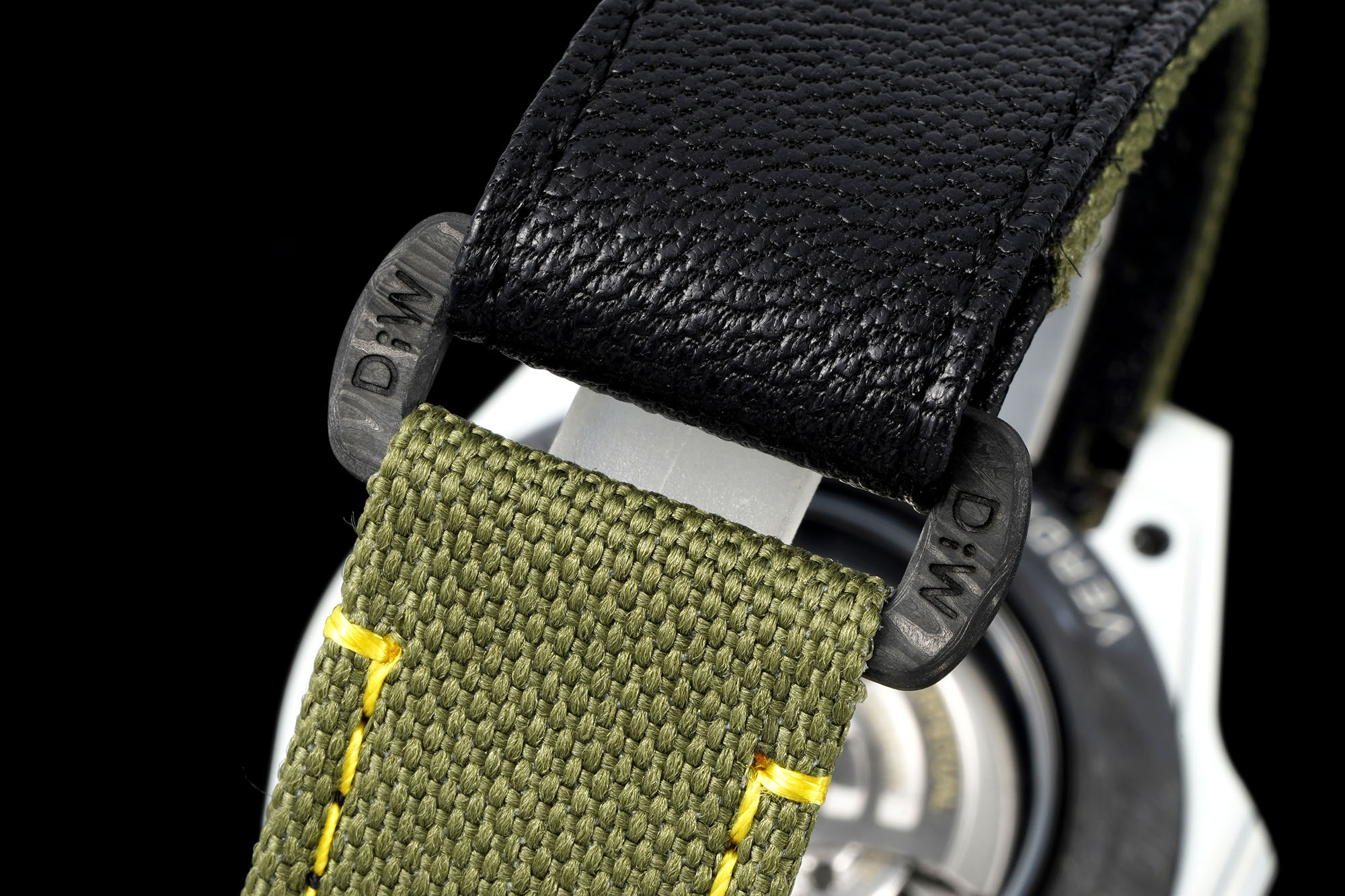 Olive green fabric strap with black leather ends and D&M branding