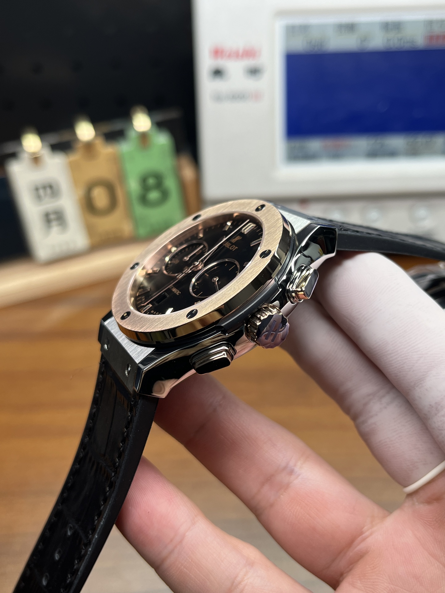 Side profile of Hublot replica watch showing case thickness polished pushers and black strap