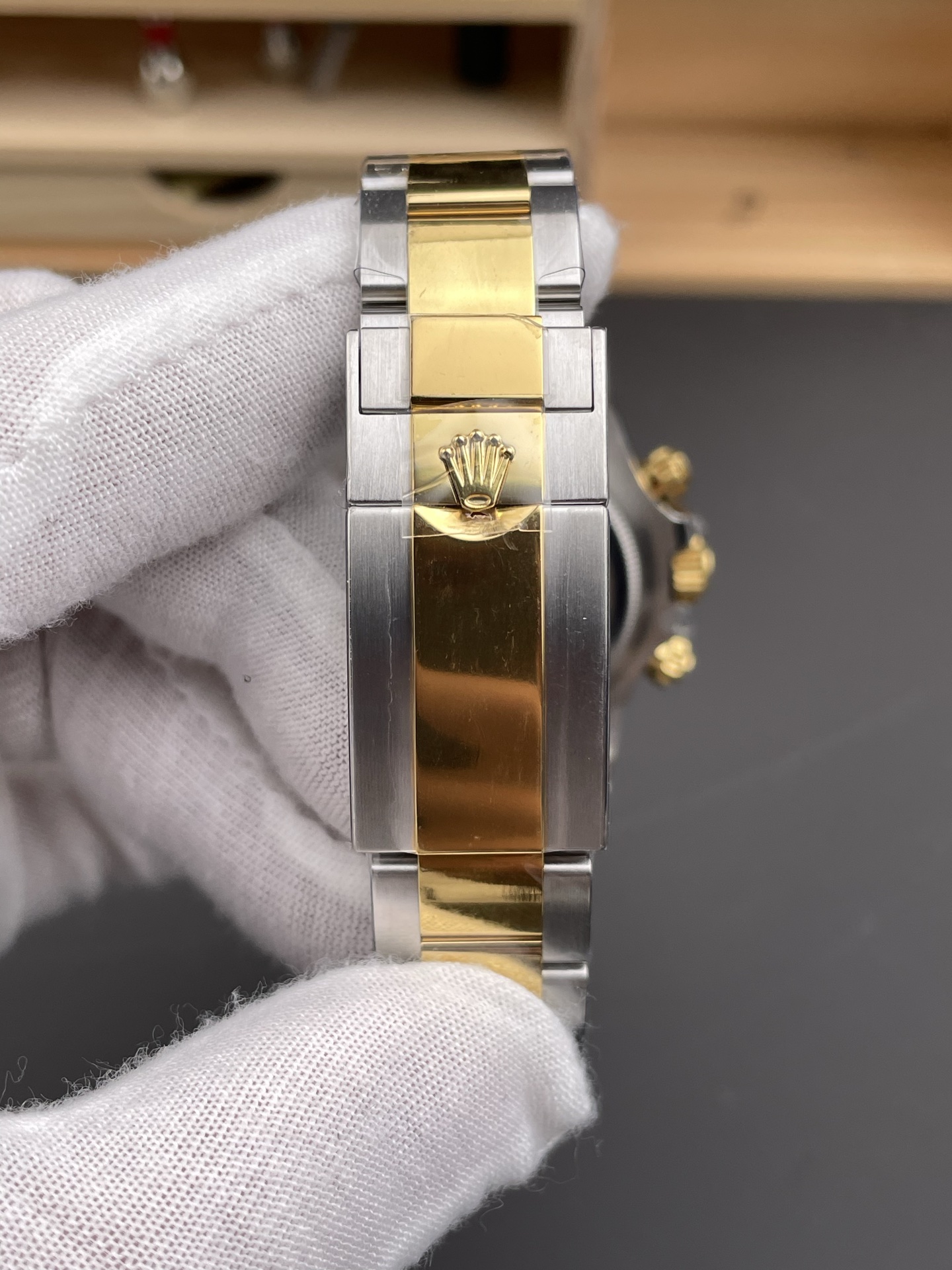 Detailed view of the two-tone Oyster bracelet with engraved Rolex crown logo on gold link