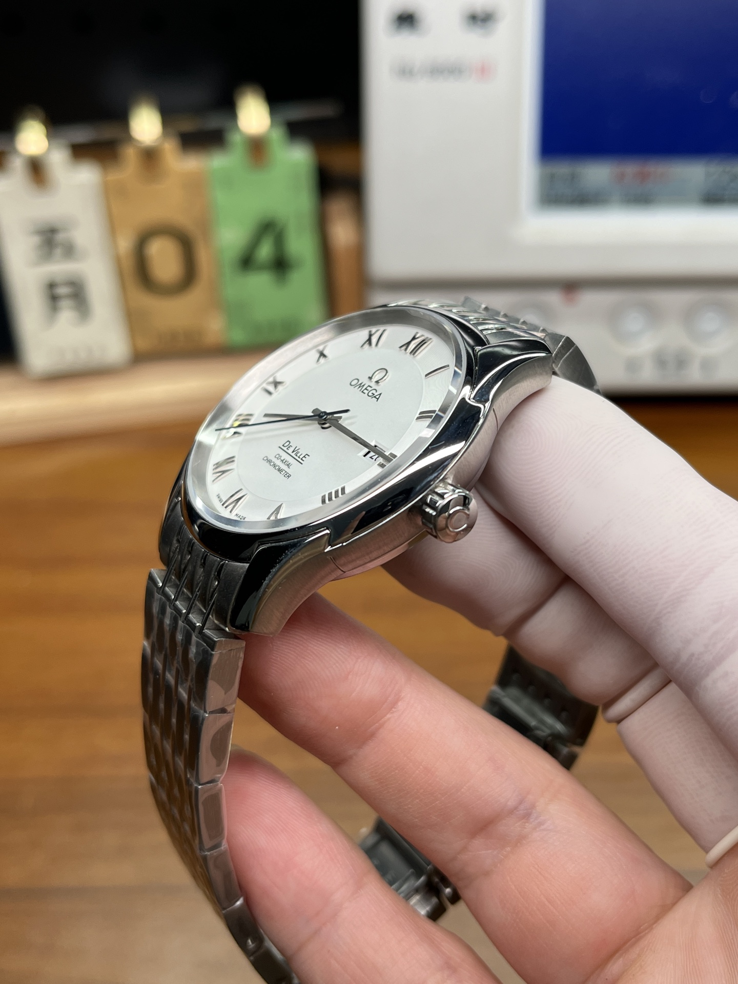 Omega De Ville replica watch angled wrist presence view