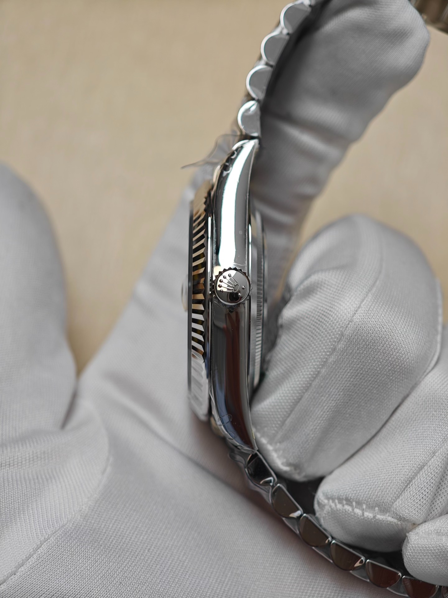 Side profile of a Rolex replica watch case and crown showing case thickness