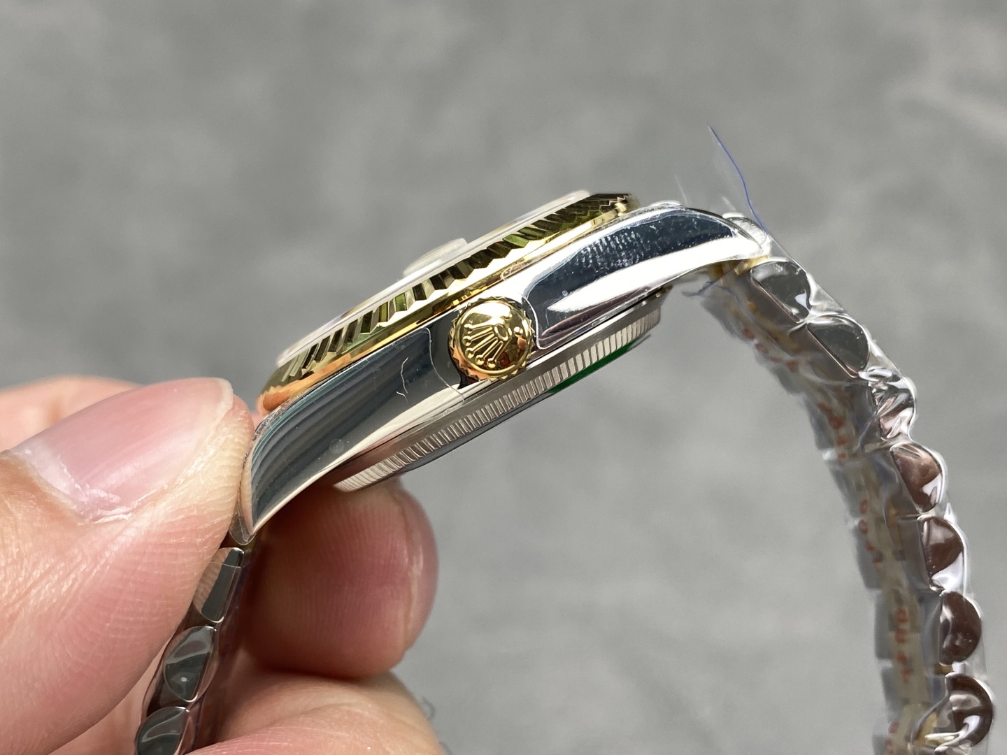 Side profile of replica rolex Datejust showing gold crown and case thickness