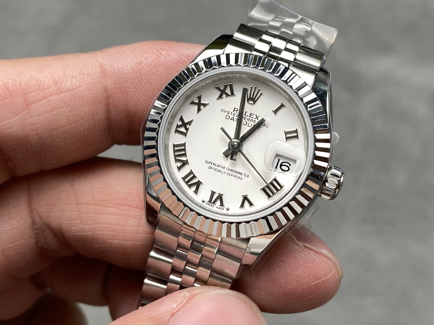 Close-up of the white dial and Roman numerals on a rolex super clone