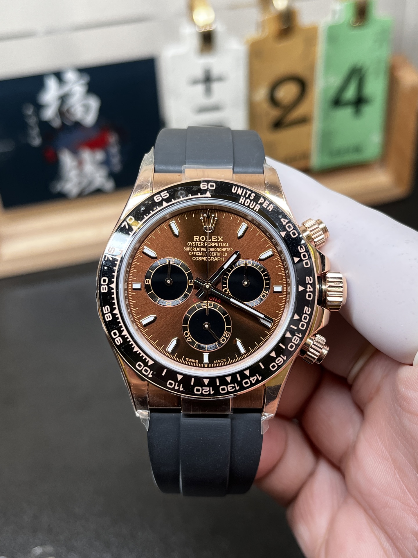 Rose gold Rolex Daytona replica with brown dial and black Oysterflex strap