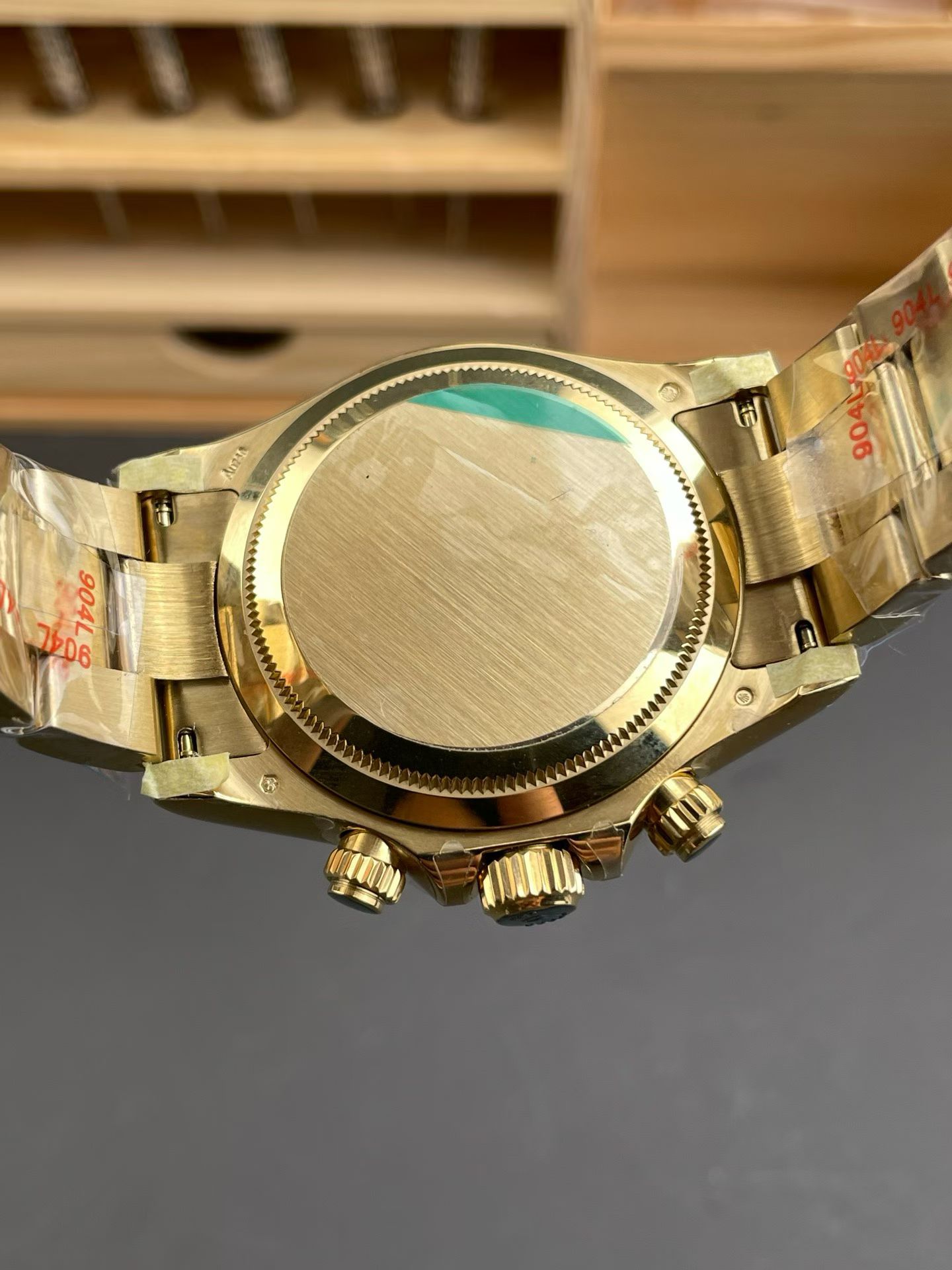 Caseback view of gold Rolex Daytona replica with bracelet protection