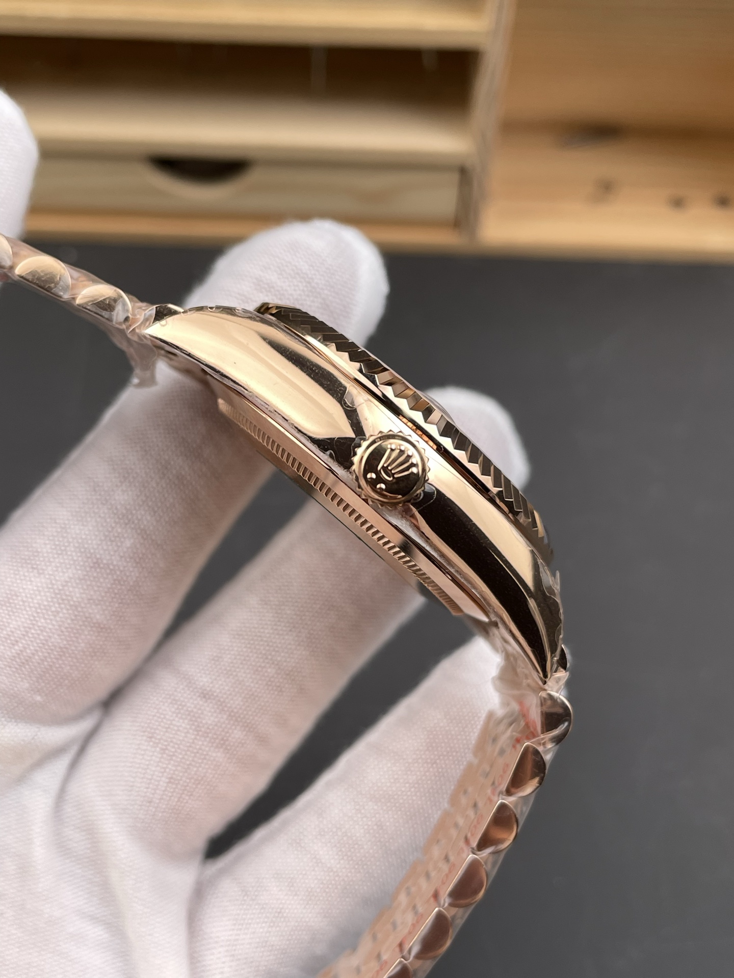 Rose gold Rolex replica side profile showing crown guard case thickness and fluted bezel