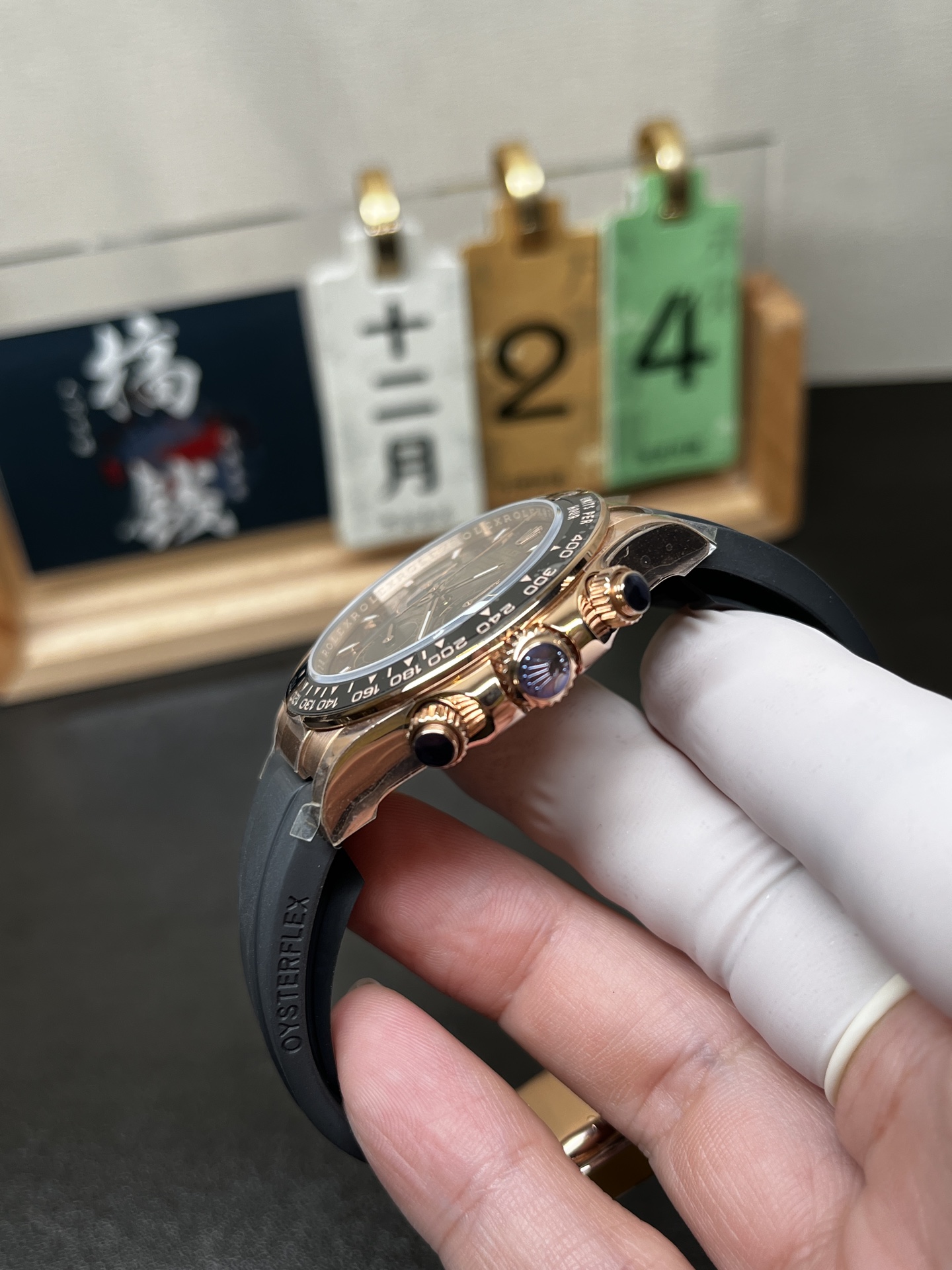 Side profile of rose gold Rolex Daytona replica case and chronograph pushers
