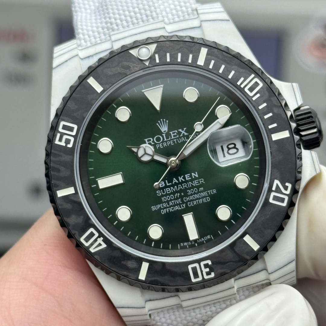 Close-up of Blaken Submariner replica with deep green glossy dial, luminous Mercedes hands, date cyclops at 18, carbon-textured bezel and white case details on high-end fake Rolex watch