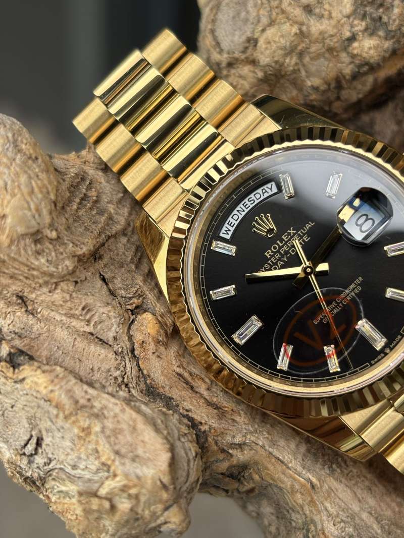 Rolex Day-Date replica 3255 yellow gold dial close-up on wood background