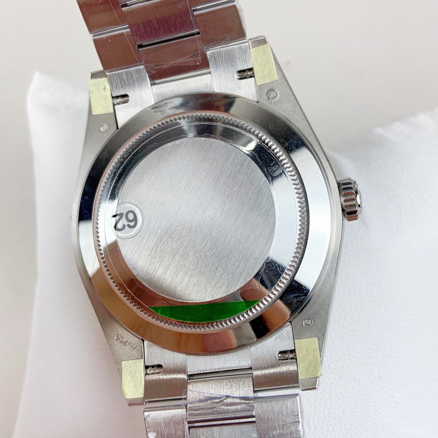 Solid case back with tooling marks and serial sticker