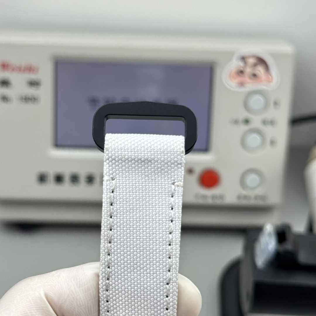 White textile strap detail for a rolex replica watch with black buckle