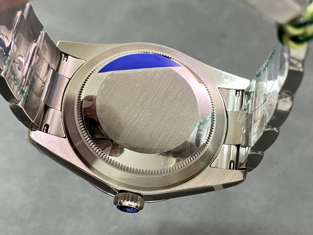 Solid case back of a high-end fake Rolex with blue protective film and brushed steel finish