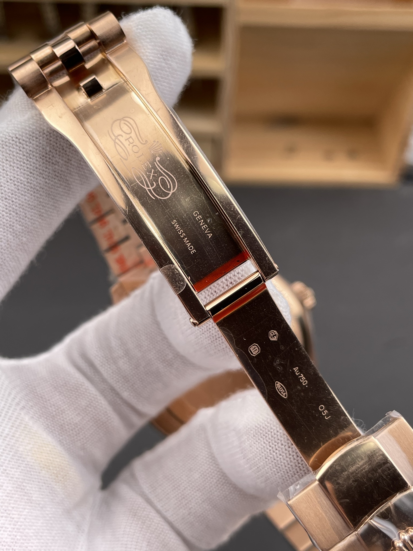 Rose gold Rolex replica clasp interior with Swiss Made markings and protective film