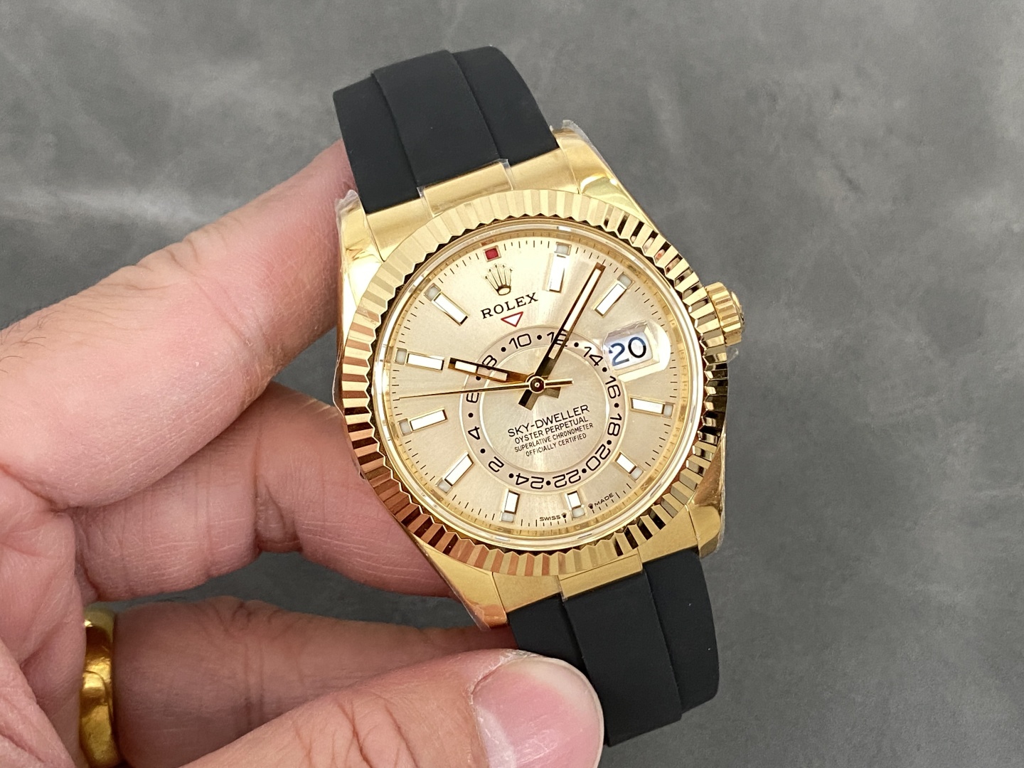Gold Rolex Sky-Dweller replica with black rubber strap and champagne dial