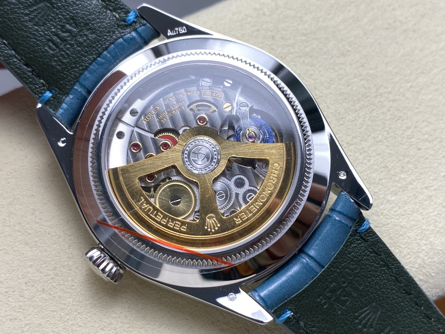 Angled side view of luxury replica Rolex with fluted bezel and blue leather strap