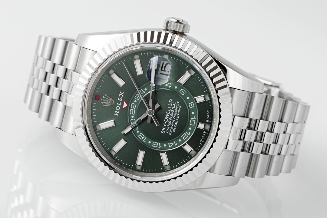 Side view of Rolex Datejust with deep green dial, fluted bezel, cyclops date magnifier, luminous hands and Oyster bracelet on white background