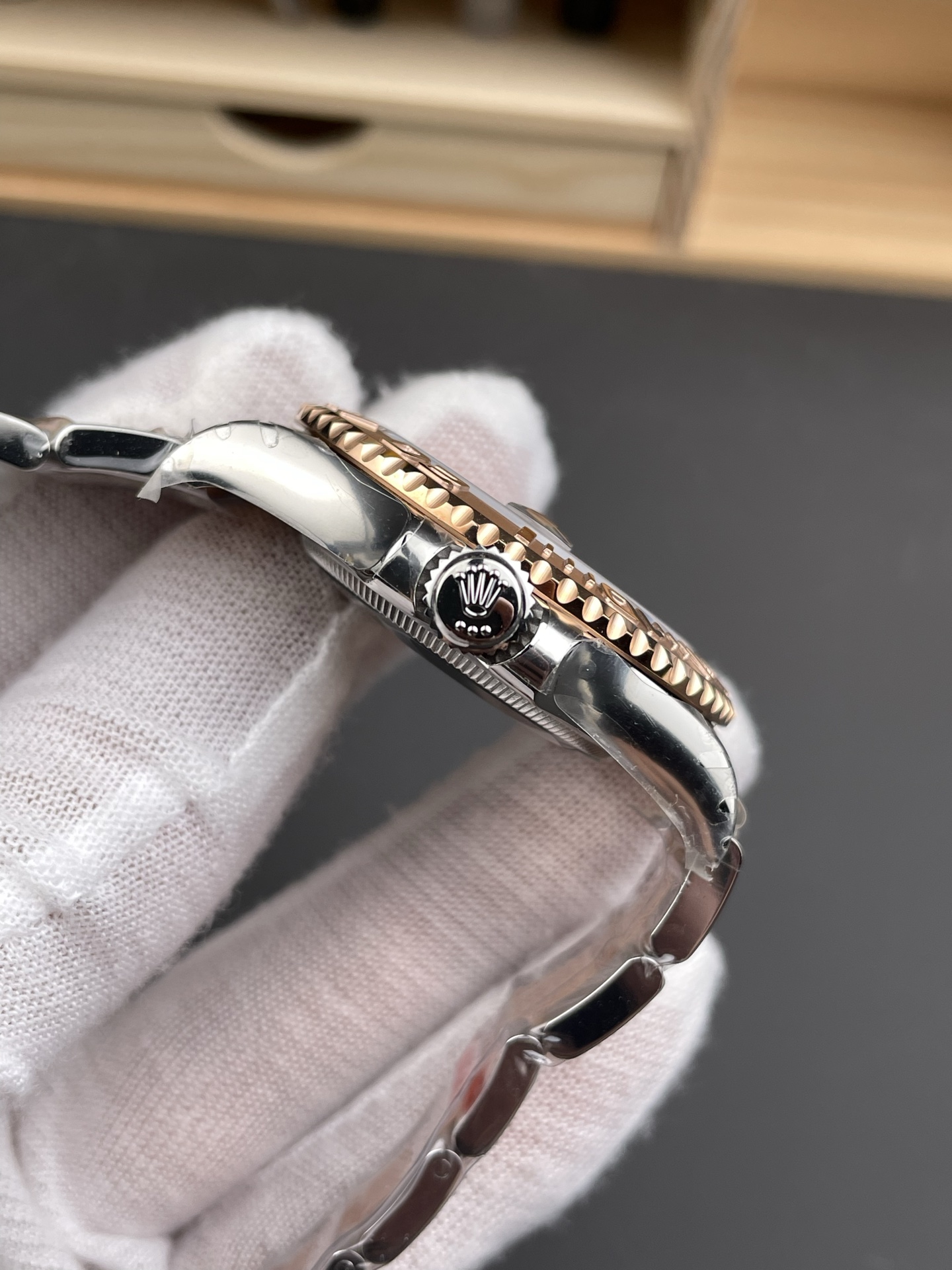 Side profile of two-tone rose gold Rolex Yacht-Master replica showing crown and bezel finishing