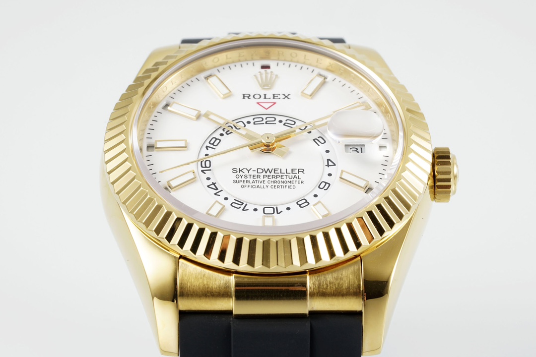 Close-up of the fluted bezel and white dial on a gold Rolex Sky-Dweller replica