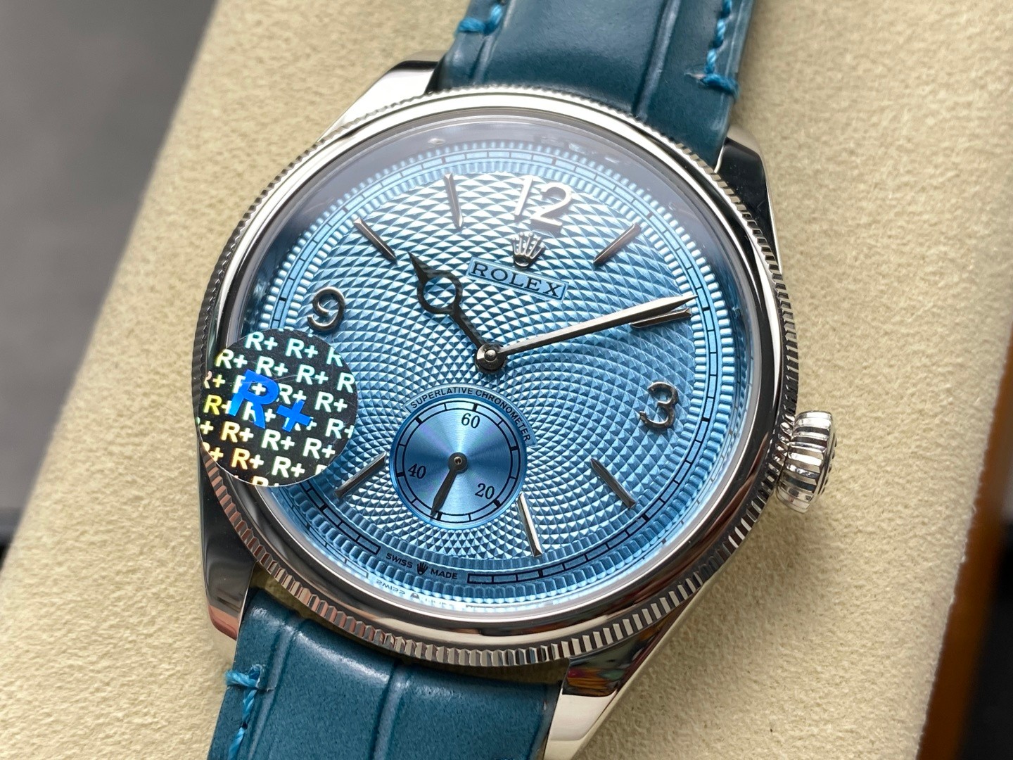 Blue guilloche dial super clone Rolex with R plus sticker, demonstrating the visual details that matter in the wrist test vs macro test