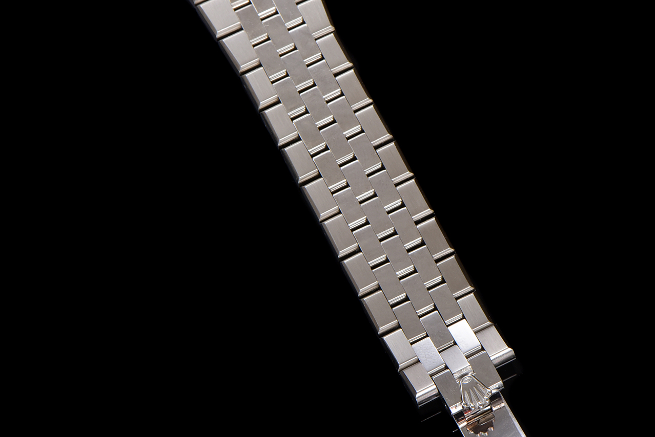 Close-up of silver integrated bracelet links on a Rolex copy watch