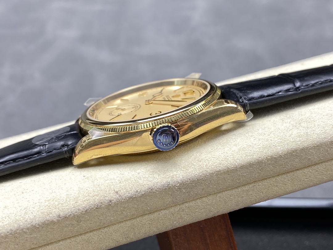 Side profile of gold replica watch with blue crown and black leather strap